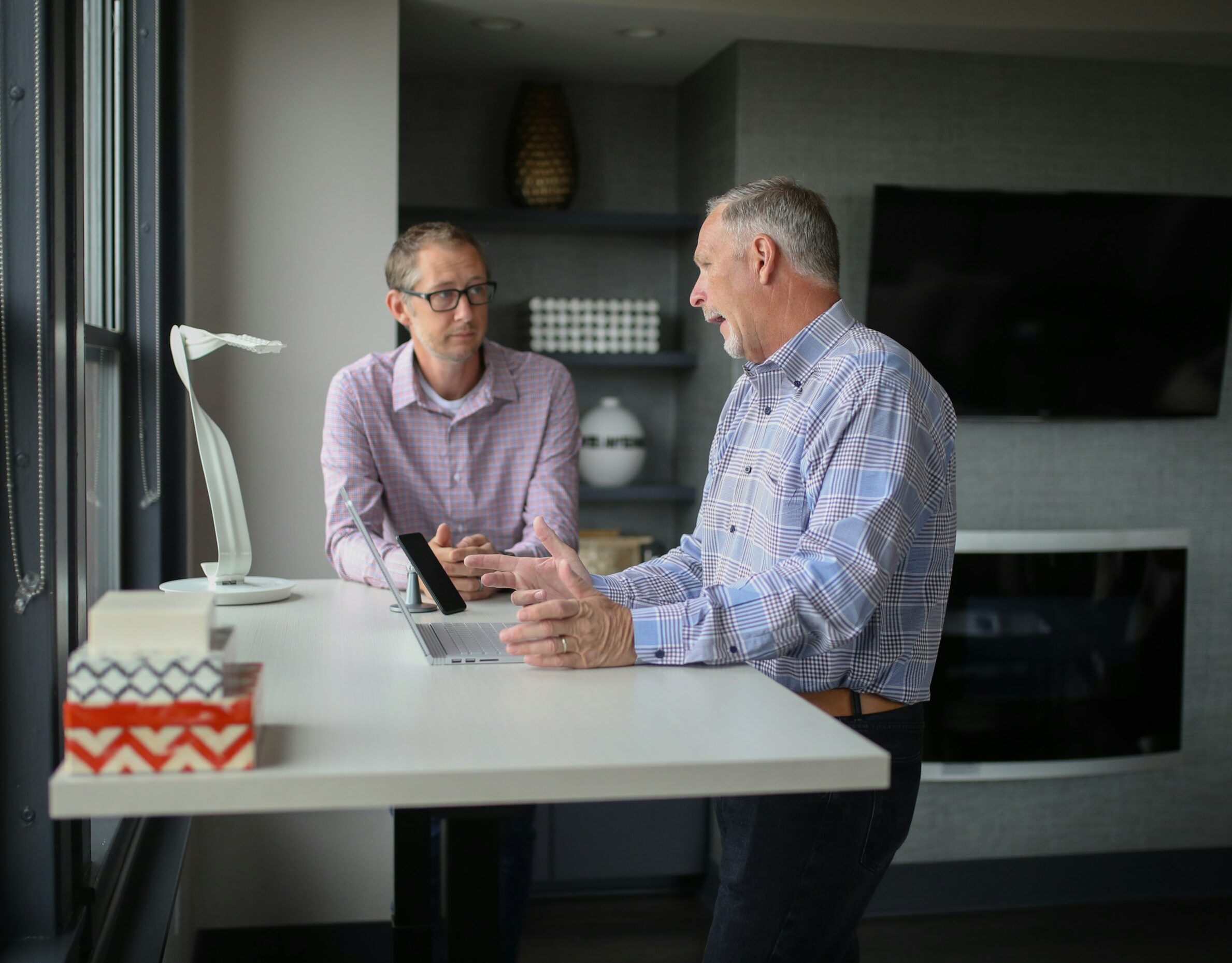 Accountant processing AR cash receipts on dual monitors